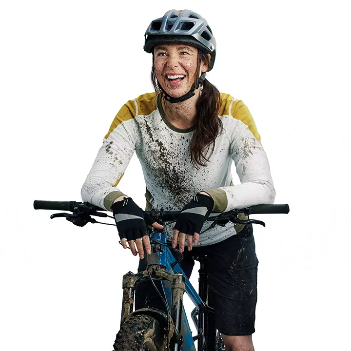 happy young woman on her new mountain bike with dirt on her body and face